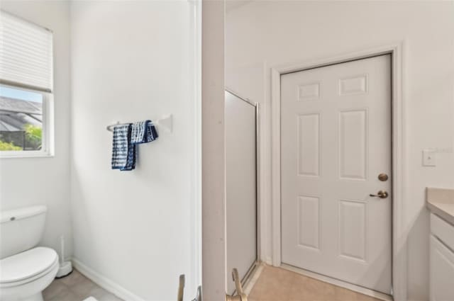 bathroom with a shower with shower door, tile patterned floors, toilet, and vanity