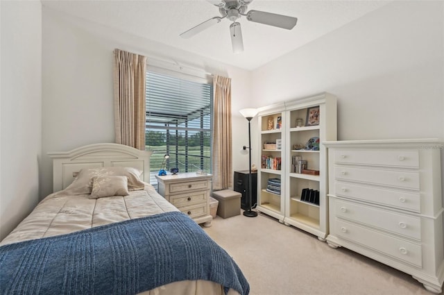 bedroom with ceiling fan and light carpet