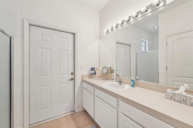 bathroom with vanity, tile patterned floors, and a shower with door