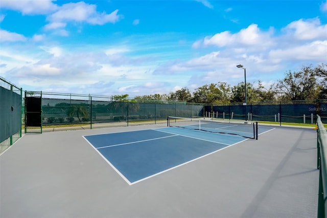 view of tennis court with basketball hoop