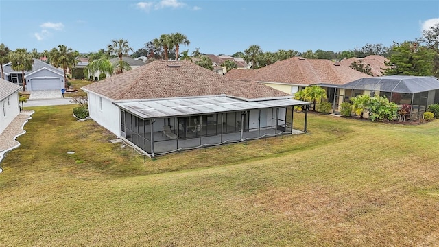 back of house featuring a yard and a sunroom