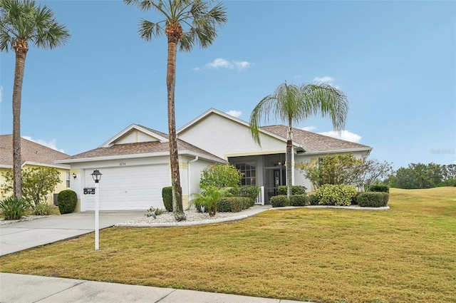 ranch-style home featuring a garage and a front yard