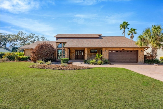 view of front of house featuring a front yard and a garage