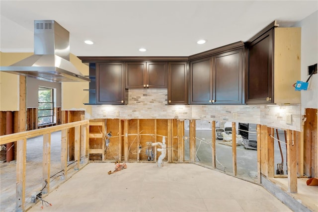 kitchen with dark brown cabinets, backsplash, and island exhaust hood