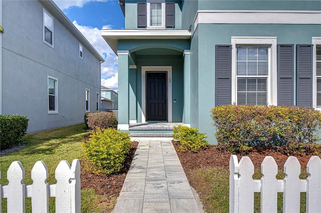 doorway to property featuring a lawn