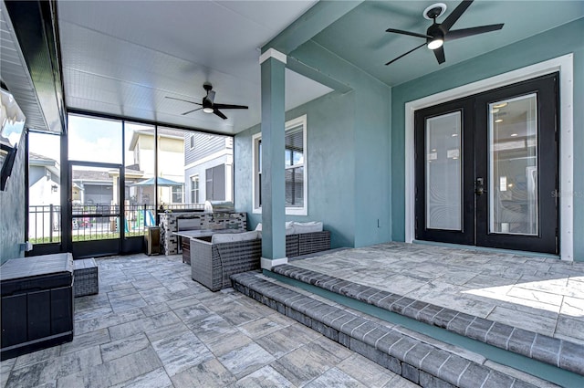 sunroom featuring french doors and ceiling fan