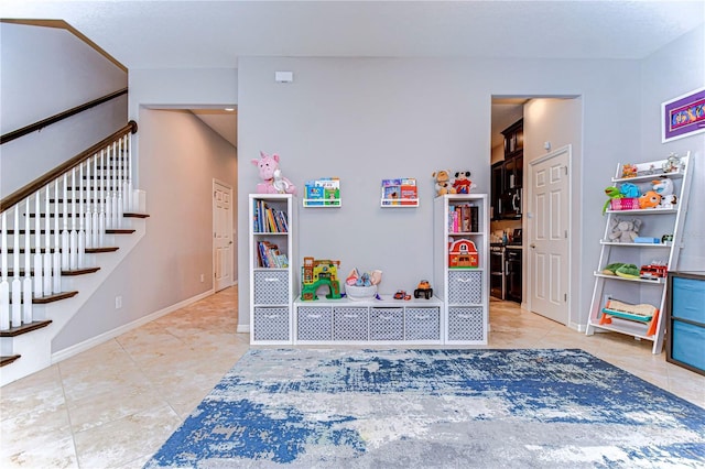 rec room featuring light tile patterned flooring