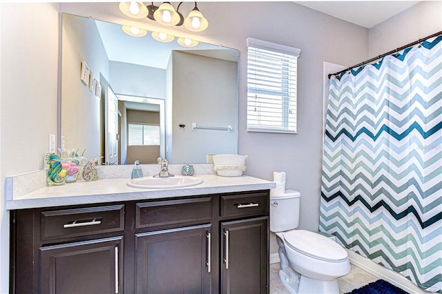 bathroom featuring walk in shower, vanity, and toilet