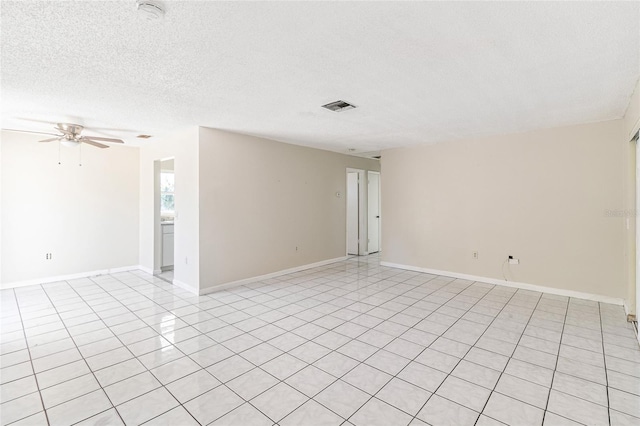 tiled spare room featuring ceiling fan and a textured ceiling