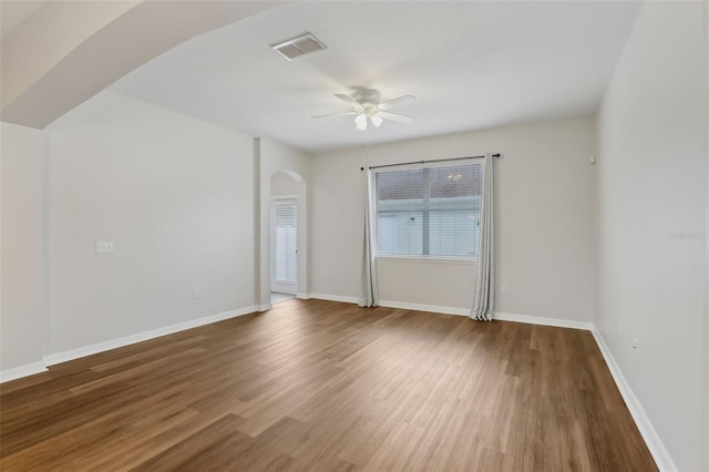 spare room with dark hardwood / wood-style floors and ceiling fan