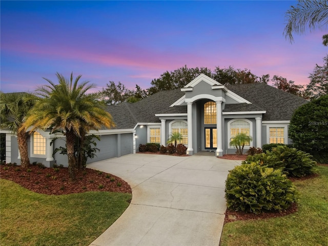 view of front of home featuring a garage and a yard