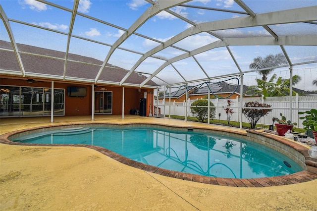 view of swimming pool featuring a lanai, a patio, and ceiling fan