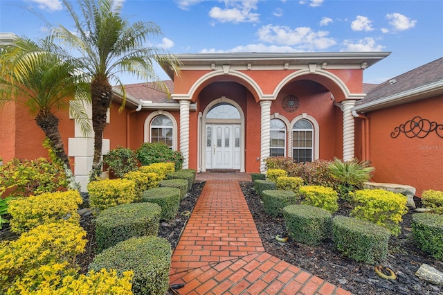 doorway to property with stucco siding