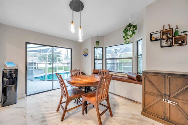 dining area featuring marble finish floor and baseboards