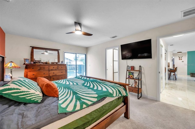 bedroom featuring ceiling fan, access to exterior, light colored carpet, and a textured ceiling