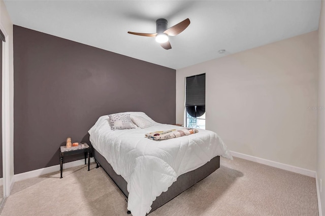 bedroom with ceiling fan and light colored carpet