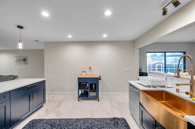 kitchen featuring stainless steel dishwasher, marble finish floor, a sink, and recessed lighting