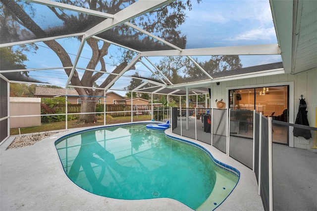 view of pool with a lanai, a patio area, a fenced backyard, and a fenced in pool