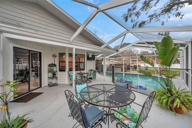 exterior space featuring a patio, outdoor dining area, and a lanai