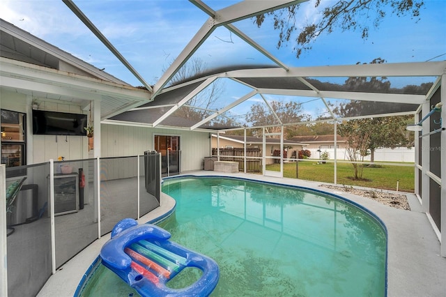 view of swimming pool with a lanai, a yard, a fenced in pool, and a patio