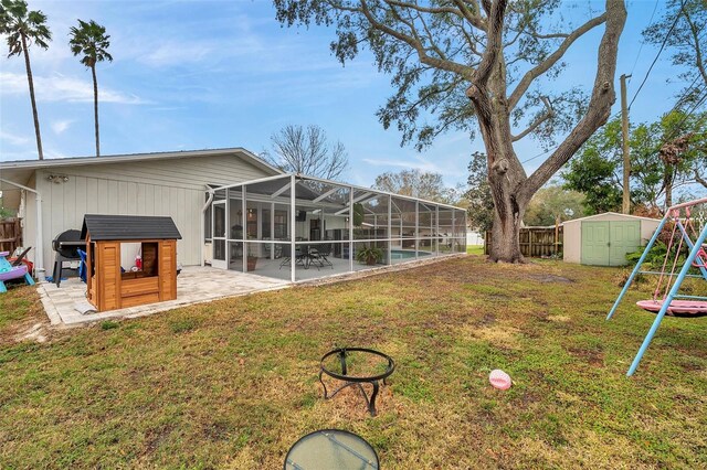 view of yard with a patio, a storage unit, an outdoor structure, and fence