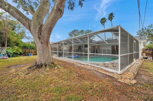 view of pool featuring a fenced in pool, a lanai, a yard, and fence