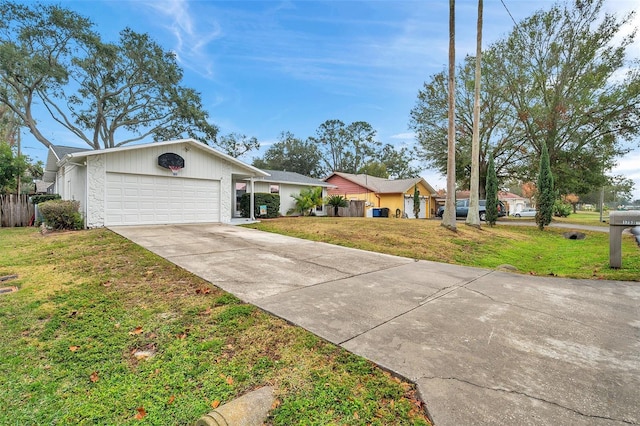 ranch-style home with concrete driveway, a front lawn, and an attached garage