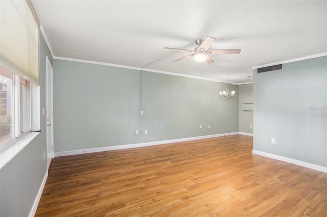 2635 Seville Blvd Unit 109, Clearwater, FL 33764 - unfurnished room with crown molding, hardwood / wood-style flooring, ceiling fan with notable chandelier, and a textured ceiling
