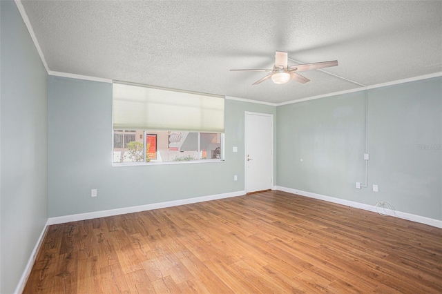 2635 Seville Blvd Unit 109, Clearwater, FL 33764 - empty room with hardwood / wood-style flooring, ceiling fan, ornamental molding, and a textured ceiling