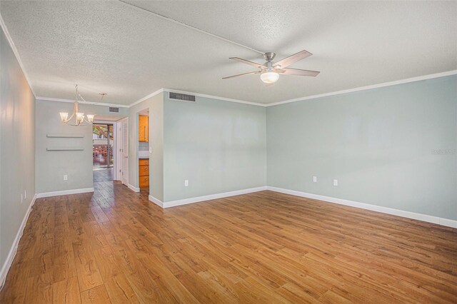 2635 Seville Blvd Unit 109, Clearwater, FL 33764 - spare room featuring hardwood / wood-style flooring, ceiling fan with notable chandelier, ornamental molding, and a textured ceiling