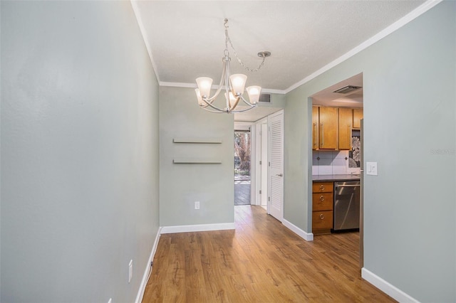 2635 Seville Blvd Unit 109, Clearwater, FL 33764 - unfurnished dining area with light wood-type flooring, an inviting chandelier, and ornamental molding