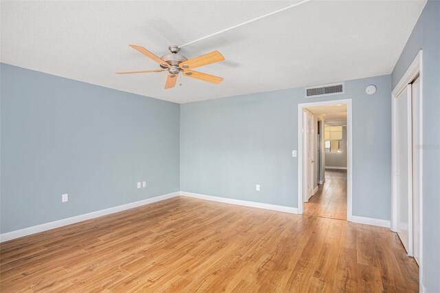 2635 Seville Blvd Unit 109, Clearwater, FL 33764 - unfurnished room featuring ceiling fan, a textured ceiling, and light hardwood / wood-style flooring