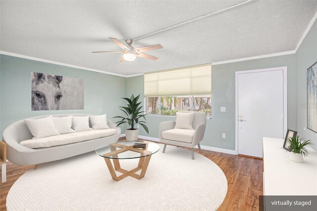 2635 Seville Blvd Unit 109, Clearwater, FL 33764 - living room with hardwood / wood-style flooring, a textured ceiling, crown molding, and ceiling fan
