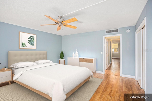 2635 Seville Blvd Unit 109, Clearwater, FL 33764 - bedroom featuring a closet, ceiling fan, light hardwood / wood-style floors, and a textured ceiling