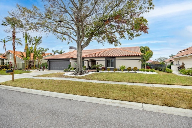 mediterranean / spanish home with a garage and a front yard