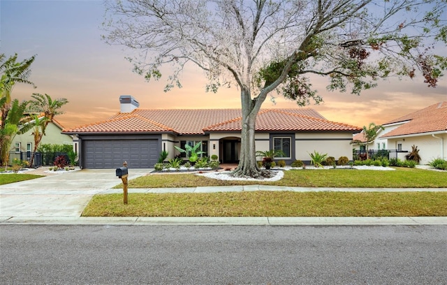 5809 Cruiser Way, Tampa, FL 33615 - mediterranean / spanish home featuring an attached garage, a tiled roof, a chimney, stucco siding, and concrete driveway