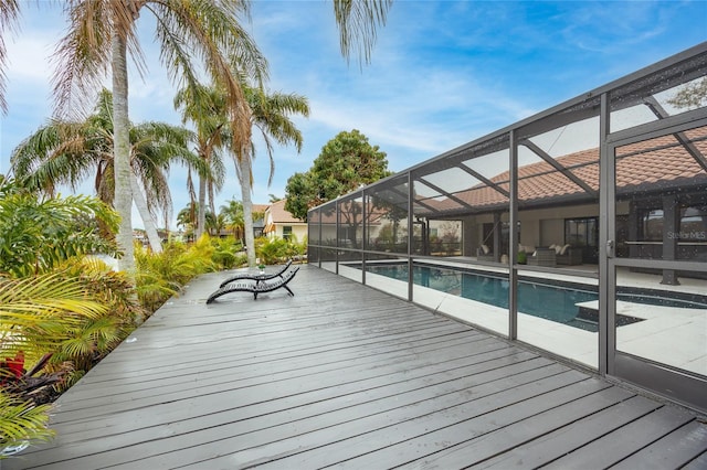 5809 Cruiser Way, Tampa, FL 33615 - wooden deck featuring an outdoor pool, a patio area, and glass enclosure