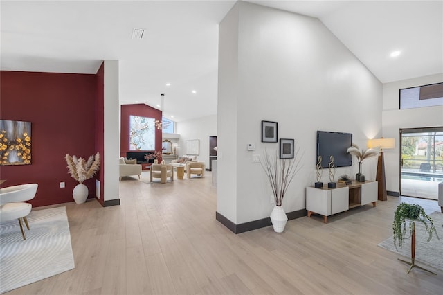 5809 Cruiser Way, Tampa, FL 33615 - living area featuring high vaulted ceiling, light wood-type flooring, and recessed lighting