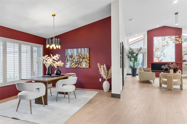 5809 Cruiser Way, Tampa, FL 33615 - dining room with vaulted ceiling, a chandelier, wood finished floors, an accent wall, and recessed lighting