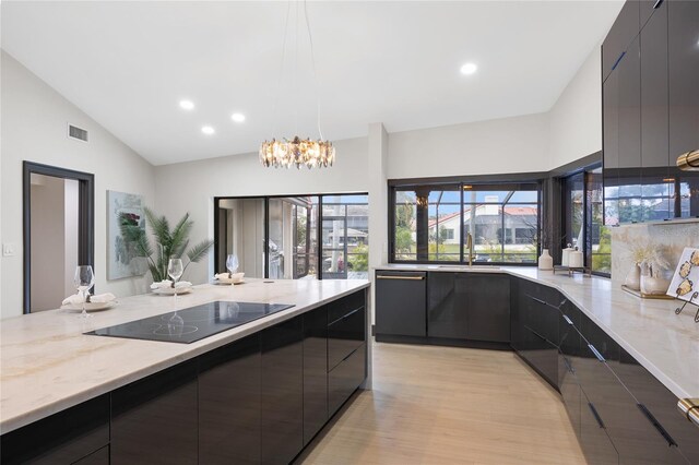 5809 Cruiser Way, Tampa, FL 33615 - kitchen featuring modern cabinets, black electric stovetop, light stone counters, light wood finished floors, and recessed lighting