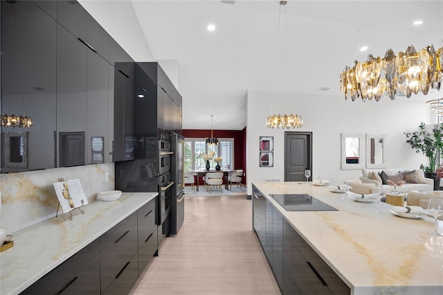5809 Cruiser Way, Tampa, FL 33615 - kitchen with modern cabinets, a chandelier, backsplash, light wood-style floors, and recessed lighting