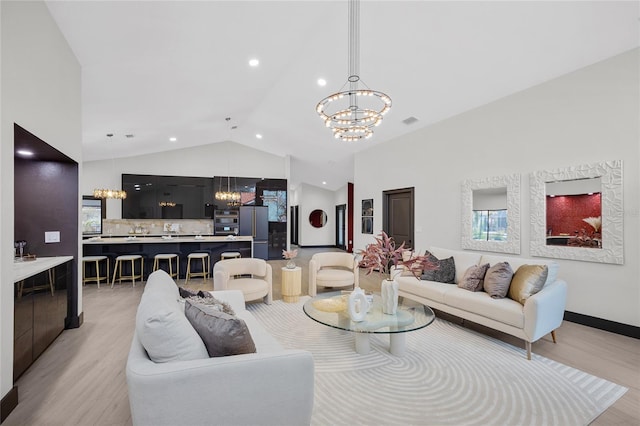 5809 Cruiser Way, Tampa, FL 33615 - living room featuring a chandelier, light wood-style floors, and high vaulted ceiling