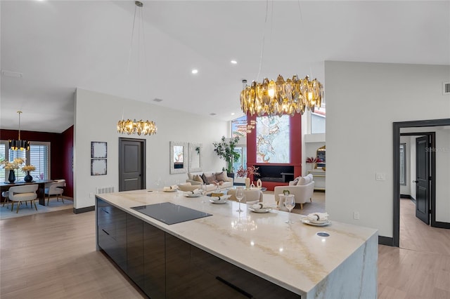 5809 Cruiser Way, Tampa, FL 33615 - kitchen featuring a chandelier, black electric cooktop, modern cabinets, recessed lighting, and a high ceiling
