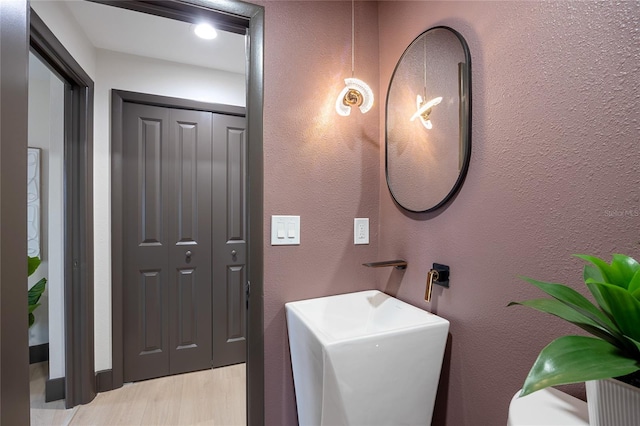 5809 Cruiser Way, Tampa, FL 33615 - bathroom with wood finished floors and a textured wall