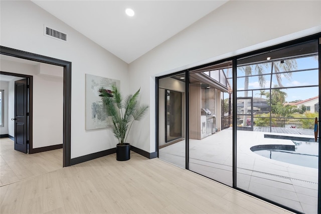 5809 Cruiser Way, Tampa, FL 33615 - unfurnished room featuring vaulted ceiling, light wood-type flooring, healthy amount of natural light, and recessed lighting