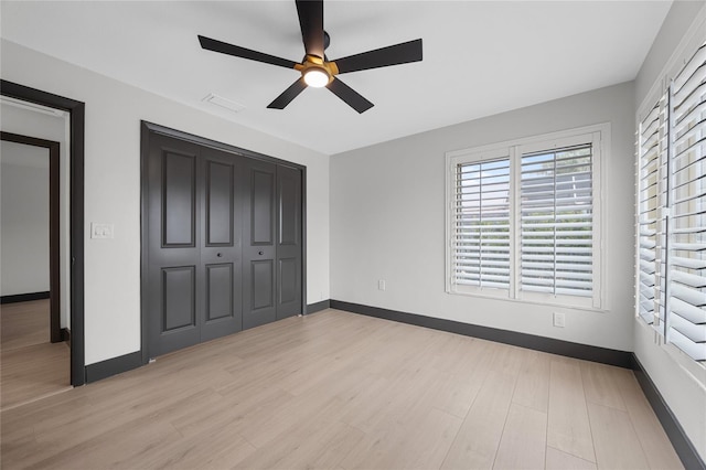 5809 Cruiser Way, Tampa, FL 33615 - unfurnished bedroom featuring light wood-style floors, multiple windows, and a closet