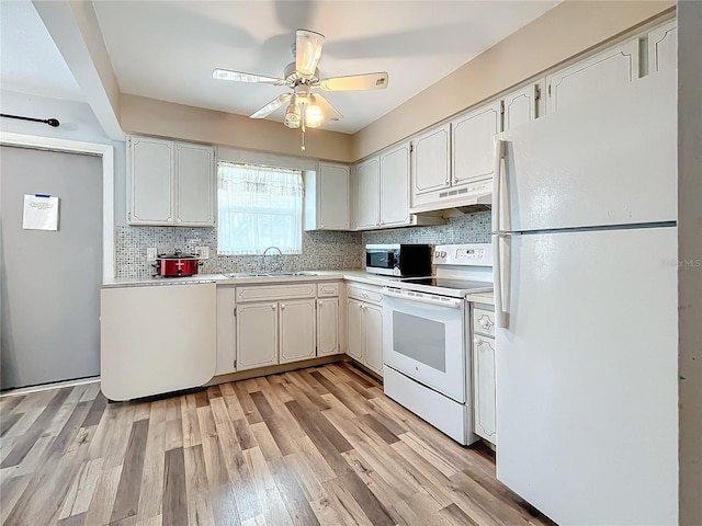 kitchen with sink, white appliances, light hardwood / wood-style flooring, ceiling fan, and decorative backsplash