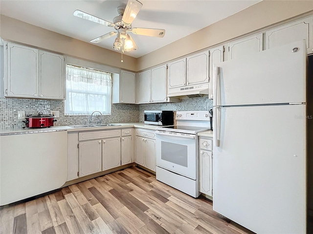 kitchen featuring white cabinetry, sink, light wood-type flooring, backsplash, and white appliances