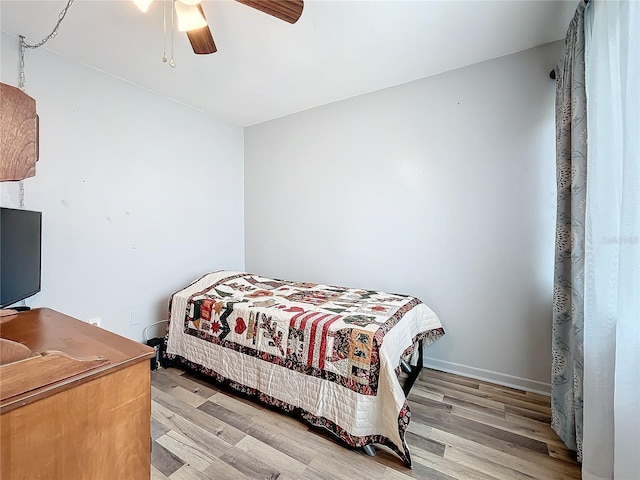 bedroom with ceiling fan and light wood-type flooring