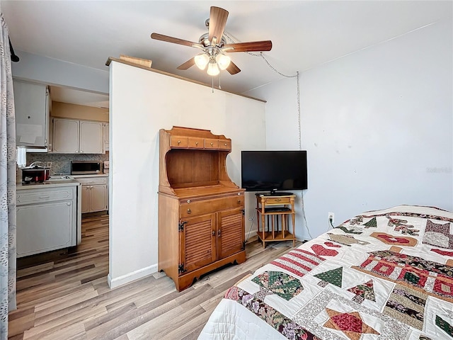 bedroom with ceiling fan and light hardwood / wood-style flooring